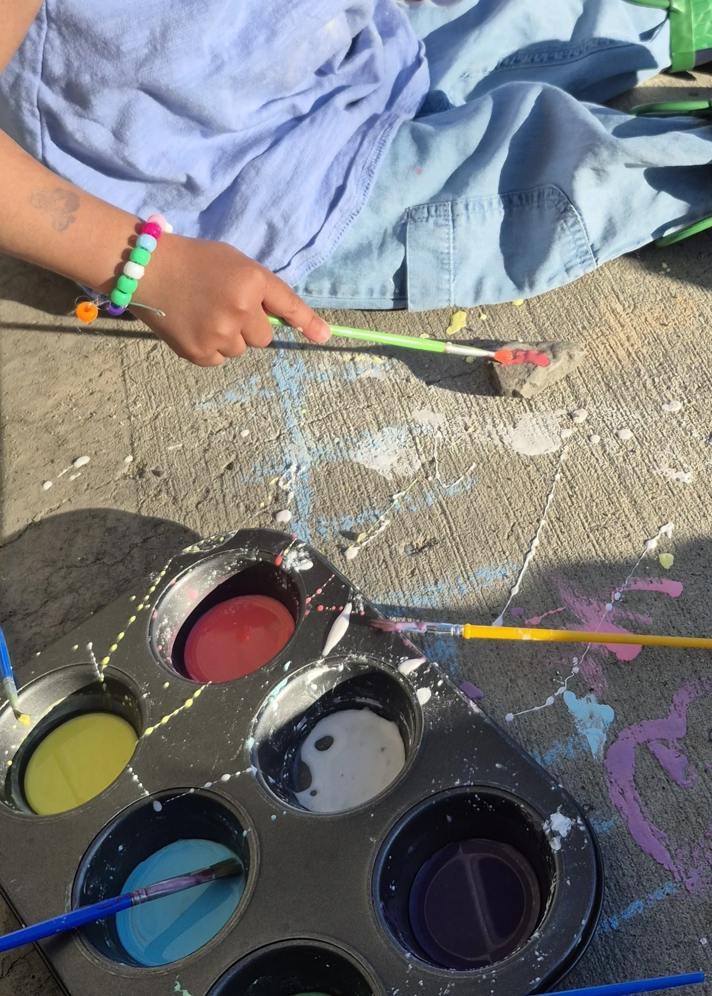 Village Scholars Preschool photo: outdoor painting with bold colours