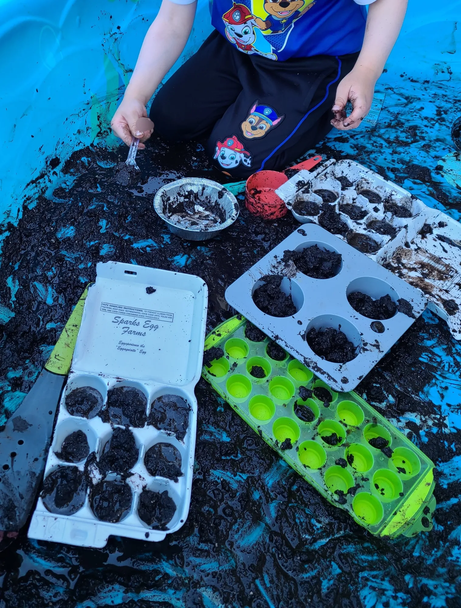Village Scholars Preschool photo: soil, scoops, and outdoor discovery trays