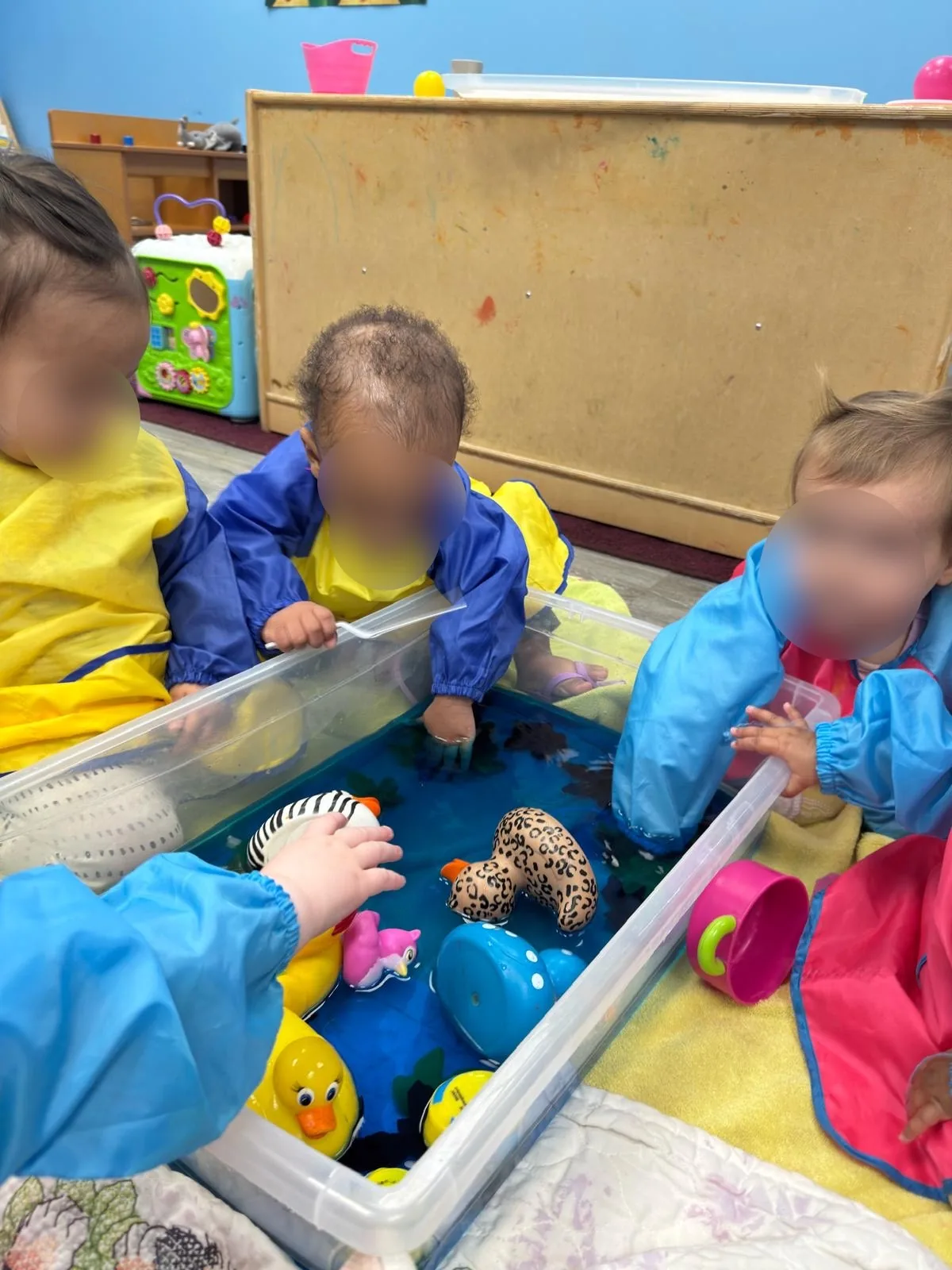 Children exploring sensory materials together at Village Scholars Preschool