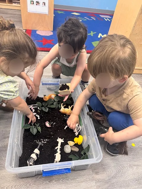 Village Scholars Preschool photo: digging through soil with friends